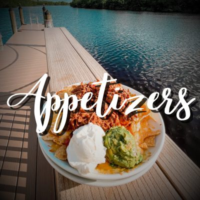 A bowl of food on the side of a river.