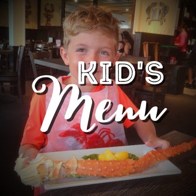 A kid sitting at the table with some food.